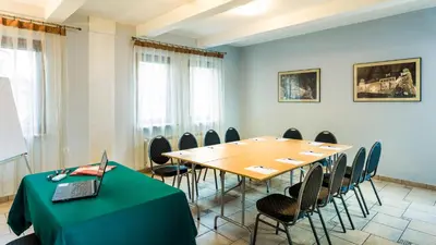 a conference room with a table with a laptop on it at Hotel City SM Business & Spa in Kraków