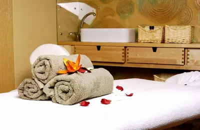 a pile of towels sitting on top of a bed at Hotel City SM Business & Spa in Kraków