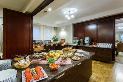 a kitchen with a bunch of food on a table at Hotel City SM Business & Spa in Kraków