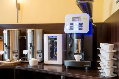 a coffee machine sitting on a counter with cups at Hotel Krakus in Kraków