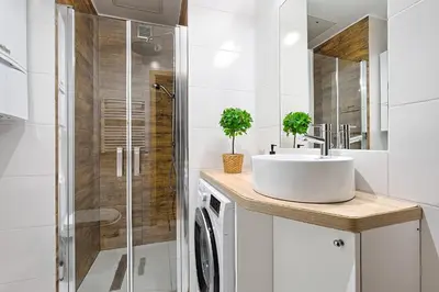 a bathroom with a sink and a shower at Urban Nest Apartments Wietora 8 in Kraków