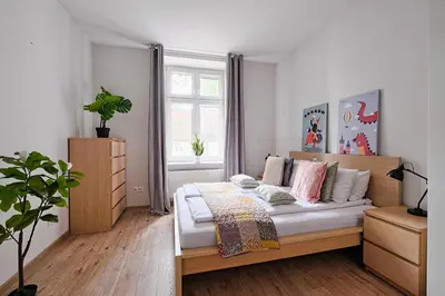 a bedroom with a bed and a window at Urban Nest Apartments Wietora 8 in Kraków