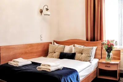 a bedroom with a bed with towels on it at Nobilton Hotel in Kraków