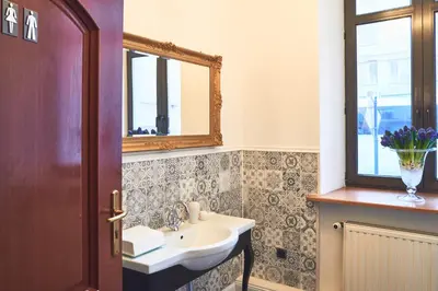 a bathroom with a sink and a mirror at Nobilton Hotel in Kraków