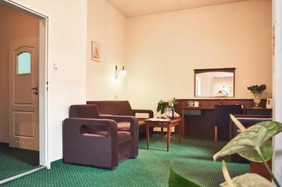 a room with two chairs and a table and a mirror at Nobilton Hotel in Kraków