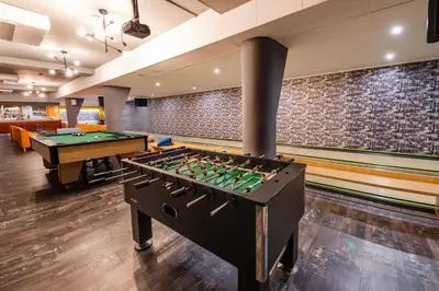 a room with a pool table and foosball at Hotel Wilga in Kraków