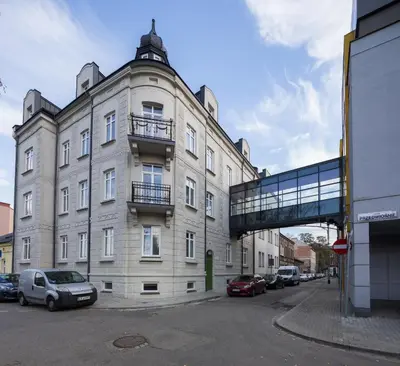 a building with a glass walkway on the side of it at Hotel Wilga in Kraków