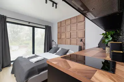 a bedroom with a bed and a large window at Modern Apartment Śródmiescie Kraków by Noclegi Renters in Kraków