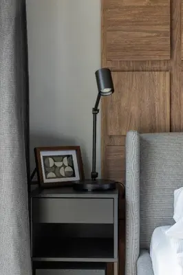 a lamp on a table next to a bed at Modern Apartment Śródmiescie Kraków by Noclegi Renters in Kraków