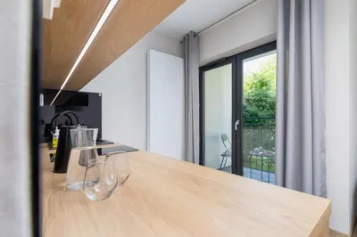 a kitchen with a wooden counter top and a window at Modern Apartment Śródmiescie Kraków by Noclegi Renters in Kraków