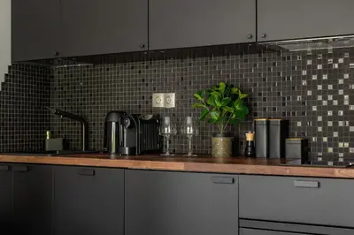 a kitchen with a counter top with a sink at Modern Apartment Śródmiescie Kraków by Noclegi Renters in Kraków