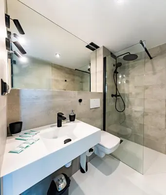 a bathroom with a sink and a shower at Domki na Łące in Libiąż