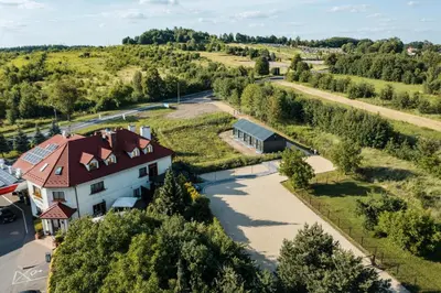 an aerial view of a house with a road and trees at Domki na Łące in Libiąż
