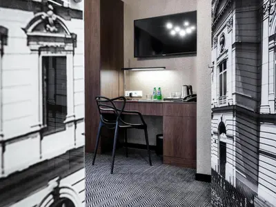 a room with a desk with a chair in a building at Hotel Logos Kraków in Kraków