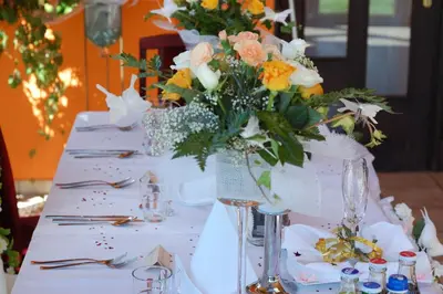 a white table with a vase of flowers on it at Hotel Bona in Kraków