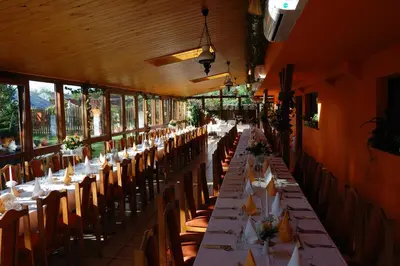 a long row of tables in a restaurant at Hotel Bona in Kraków