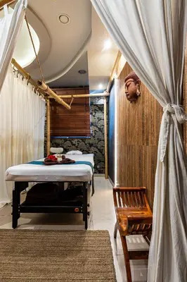 a room with a bed and a chair and a curtain at Hotel Galicja Wellness & SPA in Oświęcim