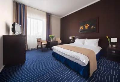 a hotel room with a bed and a television at Express Kraków Hotel in Kraków