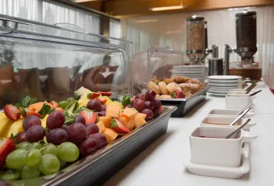 a buffet line with fruits and vegetables on display at Express Kraków Hotel in Kraków