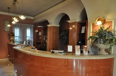 a lobby with a reception counter in a building at Hotel Wawel in Kraków