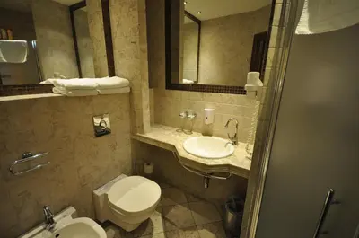 a bathroom with a toilet and a sink at Hotel Wawel in Kraków