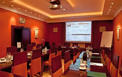 a conference room with a large screen in the middle at Hotel Wawel in Kraków
