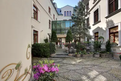 a courtyard of a building with flowers and plants at Hotel Wawel in Kraków