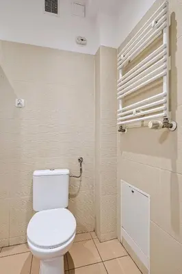 a bathroom with a white toilet in a room at Urban Nest Apartments Radziwiłłowska 14 in Kraków