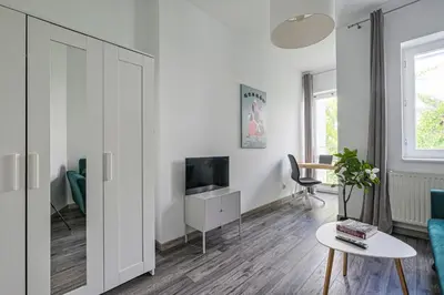 a living room with a tv and a couch and a table at Urban Nest Apartments Radziwiłłowska 14 in Kraków