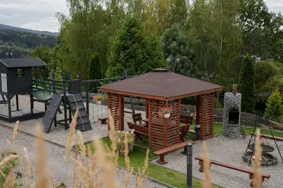 a log cabin with a snow covered roof at Domek z bali drewnianych w górach Jacuzzi & Balia - Osada Chełm in Stróża