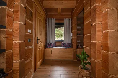 a hallway in a log cabin with a window at Domek z bali drewnianych w górach Jacuzzi & Balia - Osada Chełm in Stróża