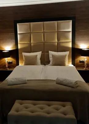 a bedroom with a large bed with a large headboard at Lake Park in Zator