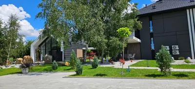 a house with a garden in front of it at Lake Park in Zator