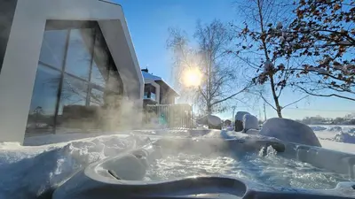 a hot tub covered in snow in front of a house at Lake Park in Zator