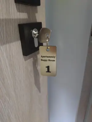 a lock on a door with a happy new year tag at Apartamenty Happy House in Zator