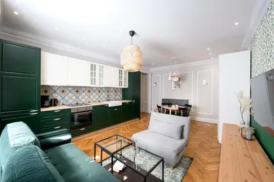 a living room with green cabinets and a green couch at Native Apartments Nowowiejska 9 Deluxe in Kraków