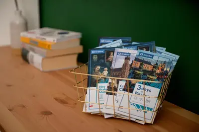 a basket of books sitting on top of a table at Native Apartments Nowowiejska 9 Deluxe in Kraków