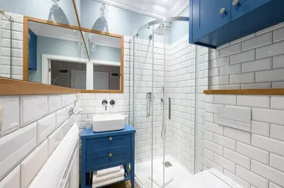 a bathroom with a blue sink and a mirror at Native Apartments Nowowiejska 9 Deluxe in Kraków