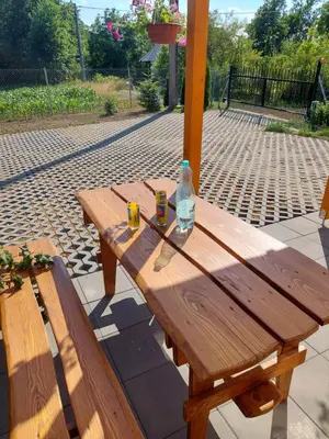 a wooden table with two glasses and a bottle on it at Domek Kalilla in Bachowice