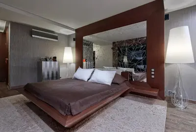 a bedroom with a large bed with a large mirror at Hotel Wentzl in Kraków