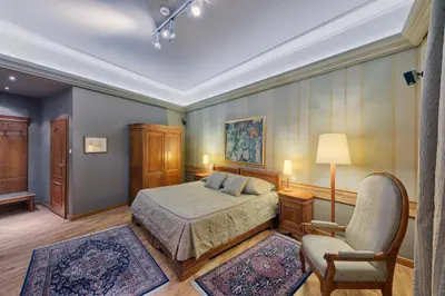a bedroom with a bed and a chair in it at Hotel Wentzl in Kraków