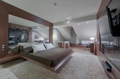 a bedroom with a large bed and a television at Hotel Wentzl in Kraków