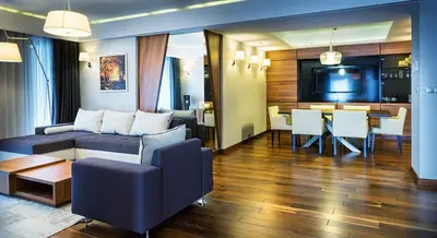 a restaurant with tables and chairs and a flat screen tv at Holiday Inn Krakow City Centre by IHG in Kraków