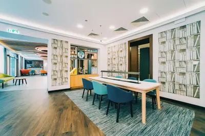 a dining room with two tables with wine bottles at Holiday Inn Krakow City Centre by IHG in Kraków