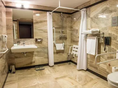 a hotel room with a bed and a flat screen tv at Holiday Inn Krakow City Centre by IHG in Kraków