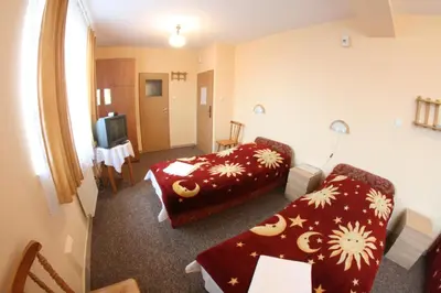 a hotel room with a bed and a couch at Hotel Daisy Budget in Kraków