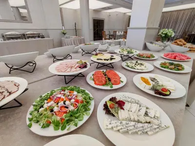 a long table with plates of food on it at Hotel Kazimierz in Kraków
