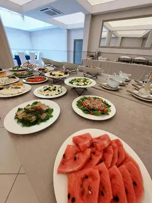 a long table with plates of food on it at Hotel Kazimierz in Kraków