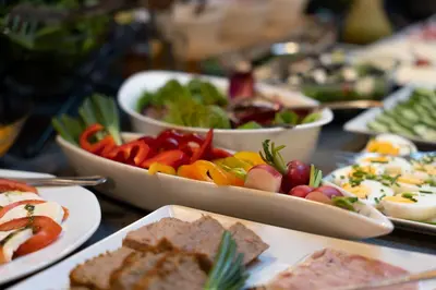 a table topped with bowls of different types of food at Hotel Secesja in Kraków
