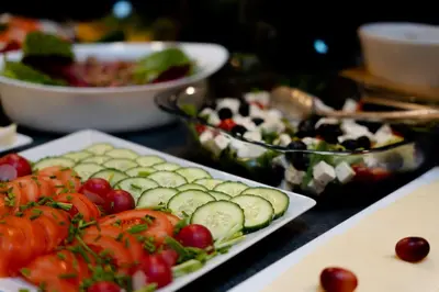 a table topped with plates of vegetables and salads at Hotel Secesja in Kraków